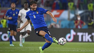 Italy's Manuel Locatelli, left, scores his side's first goal during the Euro 2020 soccer championship group A match between Italy and Switzerland at the Rome Olympic stadium,