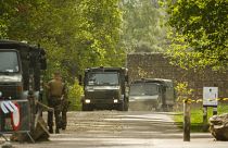 Belgian military carry equipment at the entrance of the National Park Hoge Kempen in Maasmechelen.