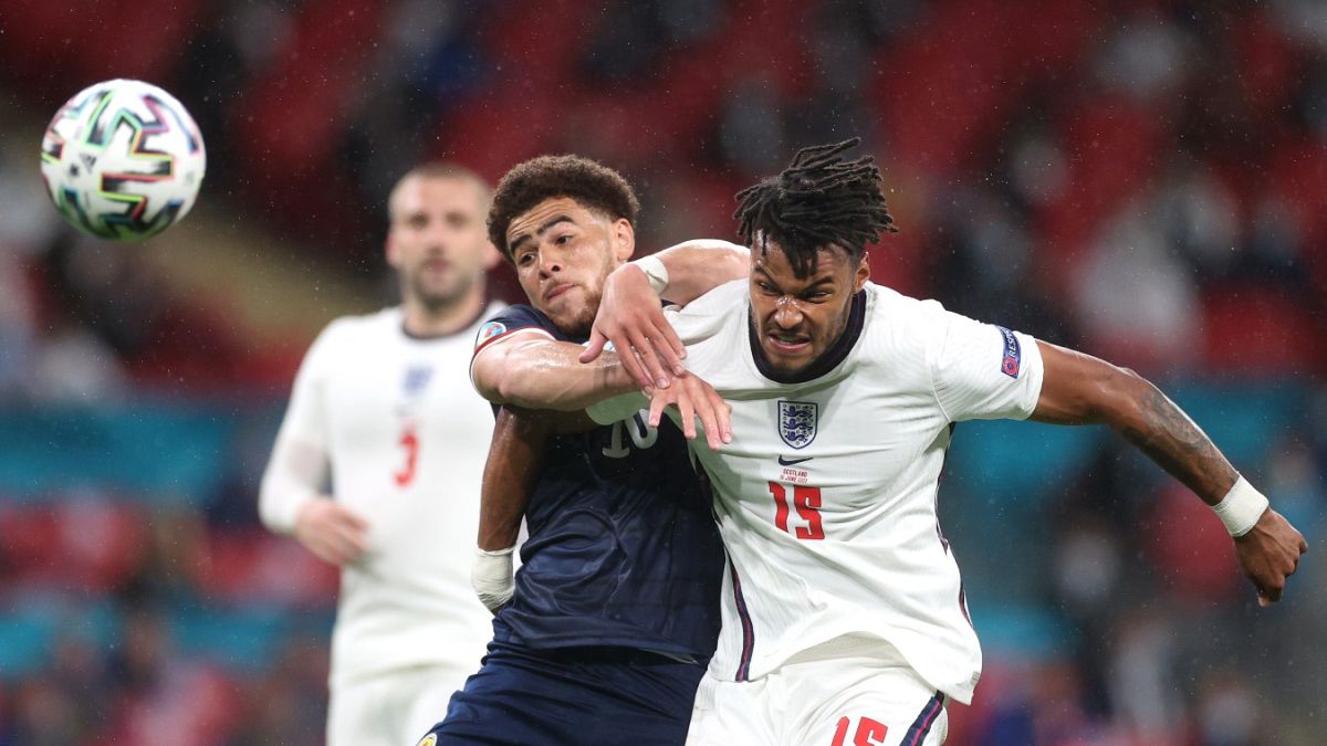 Scotland's Che Adams, left, and England's Tyrone Mings compete for the ball during the Euro 2020 match between England and Scotland Friday, June 18, 2021