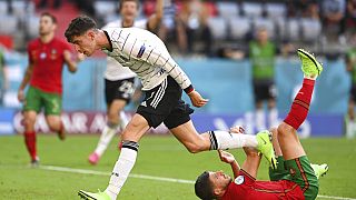 Germany's Kai Havertz and Portugal's Ruben Dias, right, after the latter scored an own goal during the Euro 2020 Group F match on Saturday