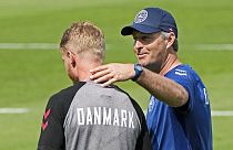 Denmark's captain Simon Kjaer, left, gets touched on the shoulder by Denmark's manager Kasper Hjulmand during a training session at the training ground in Helsingor, Denmark.