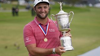 Jon Rahm holds aloft the US Open trophy for photographers after the final round at Torrey Pines Golf Course in San Diego.