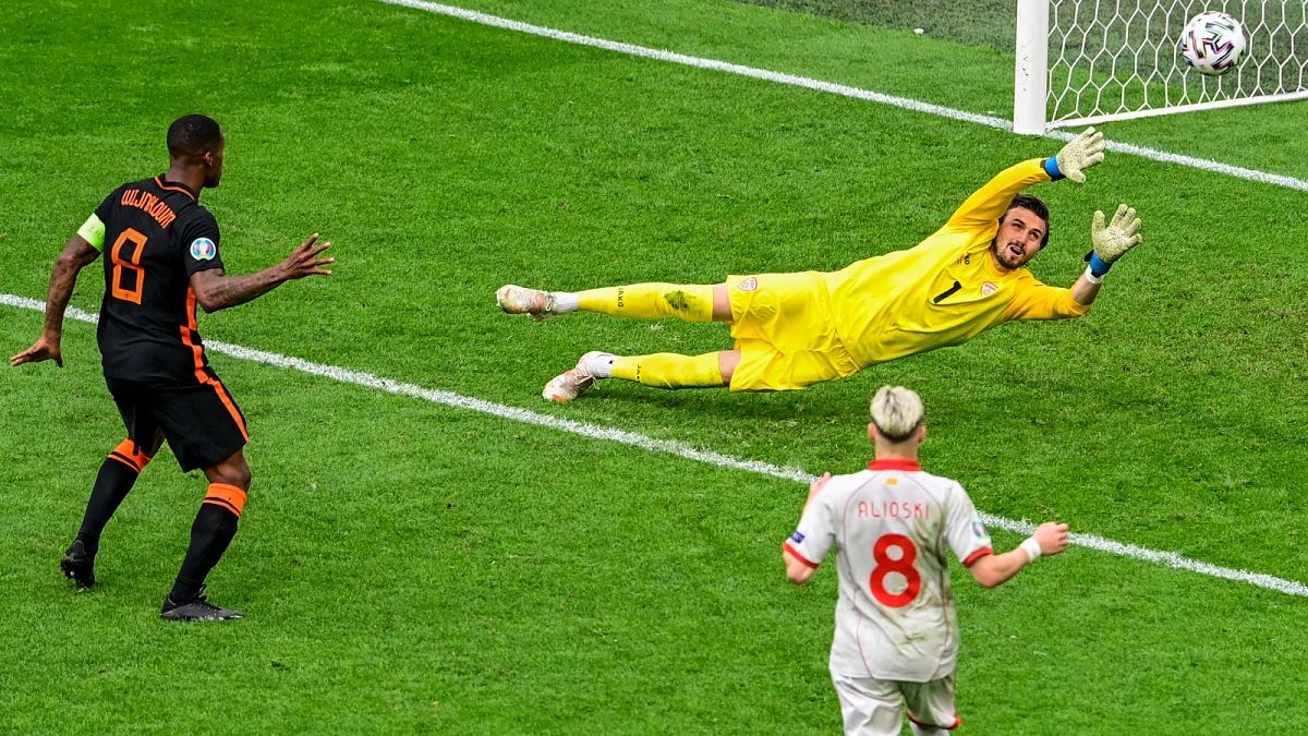 Georginio Wijnaldum of the Netherlands, left, scores his team's third goal during the Euro 2020 match between against North Macedonia in Amsterdam, Monday, June 21, 2021