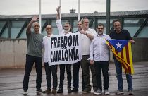 The released Catalan leaders hold a banner and a Catalan pro-independence flag outside Lledoners prison in Sant Joan de Vilatorrada.