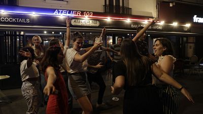 Music enthusiasts dance in Paris on June 21, 2021 during the French Festival of Music