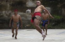 An indigenous man plays Mayan ball game