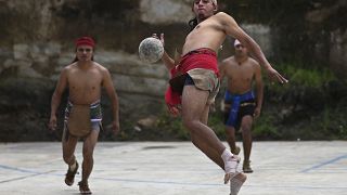 An indigenous man plays Mayan ball game