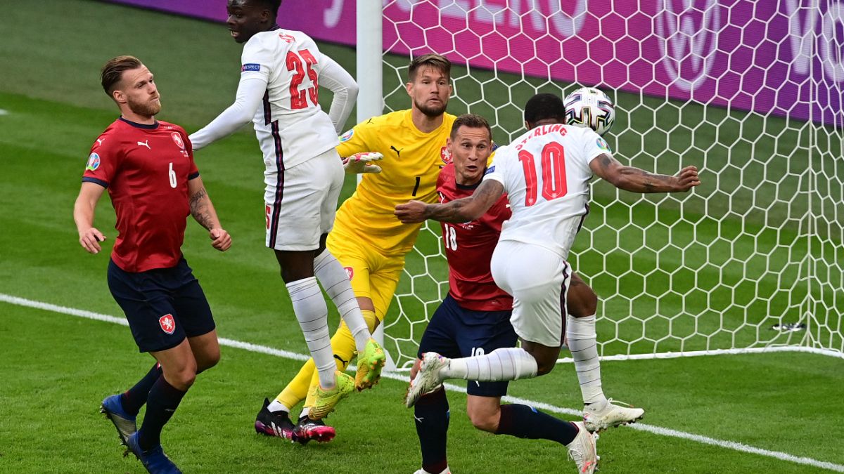 England's Raheem Sterling (R) scores the only goal during the UEFA EURO 2020 Group D match between Czech Republic and England at Wembley Stadium in London on June 22, 2021. 