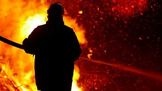 A firefighter stands in front of a blaze. New Augmented Reality technology is aiding firefighters in California.