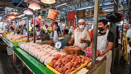 Vendors wait for customers at the Chow Kit wet market in Kuala Lumpur on April 21, 2021.