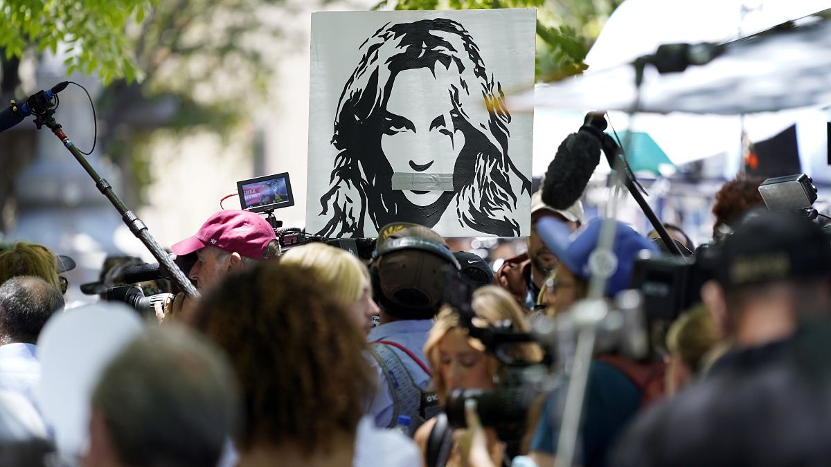 A portrait of Britney Spears looms over supporters and media members outside a court hearing over the singer's conservatorship in Los Angeles on July 23, 2021.