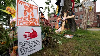 Signs are pictured at a memorial outside the Residential School in Kamloops, British Columbia., June, 13, 2021. 