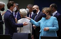 Germany's Chancellor Angela Merkel talks to Austrian Chancellor Sebastian Kurz on the first day of the EU summit 