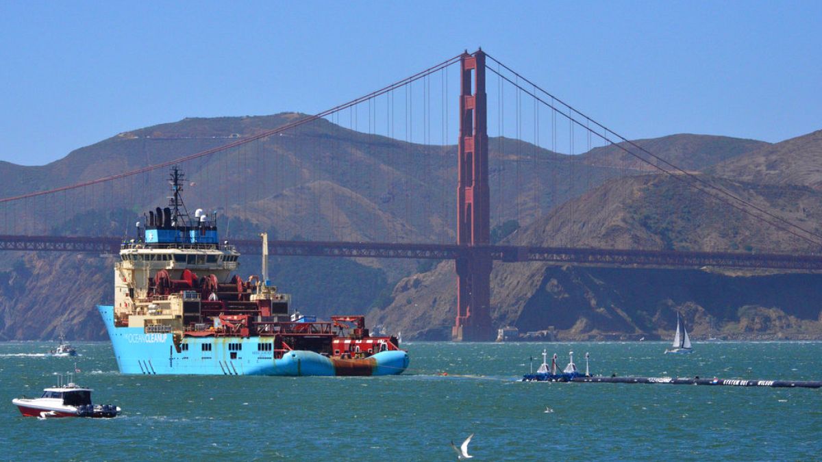 FILE: A ship tows The Ocean Cleanup's first buoyant trash-collecting device toward the Golden Gate Bridge en route to the Pacific Ocean (2018)