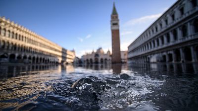 In this file photo taken on November 14, 2019 water is covering the St. Mark’s Square in Venice, Italy.
