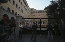 Journalists and cameramen stand outside Petraki Monastery in Athens following an attack.