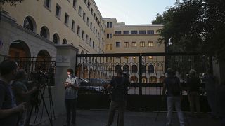 Journalists and cameramen stand outside Petraki Monastery in Athens following an attack.