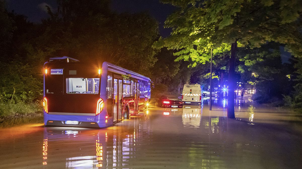 A bus is pictured stuck in water on a flooded road in Munich on Wednesday night.