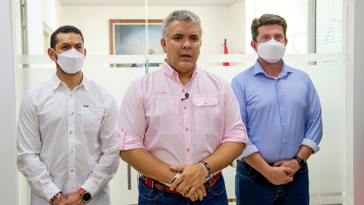President Ivan Duque speaks, flanked by Interior Minster Daniel Palacios, left, and Defence Minister Diego Molano, in Cucuta, Colombia, Friday, June 25, 2021.