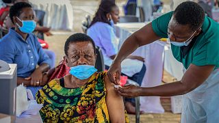 A woman receives a coronavirus vaccination at the Kololo airstrip in Kampala, Uganda.