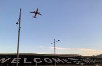 A giant sign painted near the main runway of the Wellington International Airport greets travellers returning home on April 19, 2021.