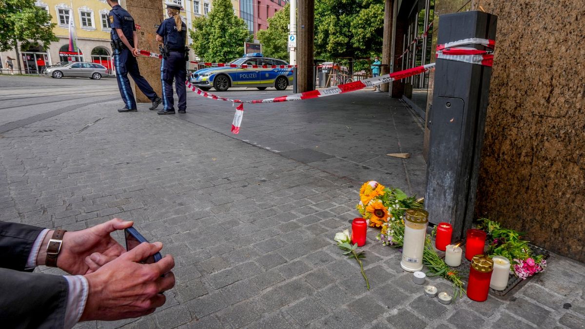 Flowers and candles were laid at the crime scene in central Wuerzburg, Germany, Saturday, June 26, 2021.
