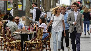 FILE: People walk at the Champs Elysees avenue in Paris, Thursday, June 17, 2021. 