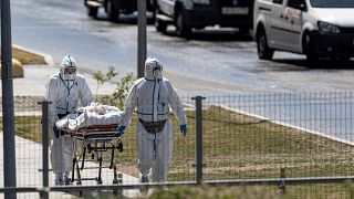 Medical workers carry a patient suspected of having coronavirus on a stretcher at a hospital in Kommunarka, outside Moscow