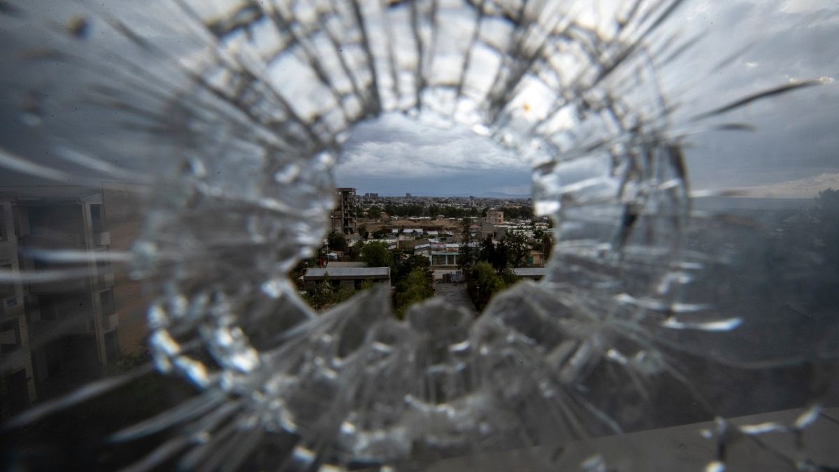 The city of Mekele is seen through a bullet hole in a stairway window of the Ayder Referral Hospital, in the Tigray region of northern Ethiopia, May 6, 2021.