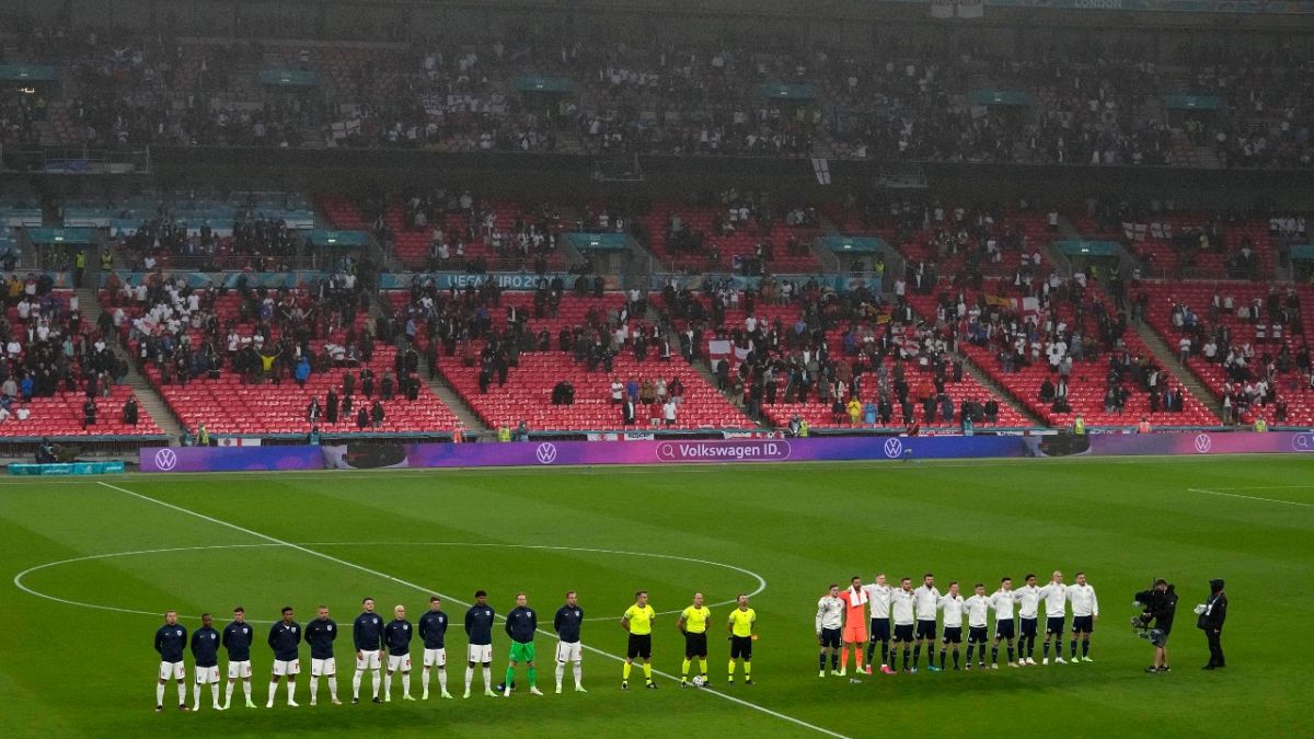 Players stand for national anthems during the Euro 2020 match between England and Scotland, at Wembley Stadium, in London, Friday, June 18, 2021.