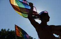 Participants wave flags and dance during the Gay Pride parade in Madrid, Spain