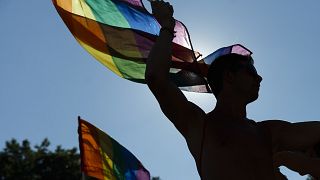 Participants wave flags and dance during the Gay Pride parade in Madrid, Spain