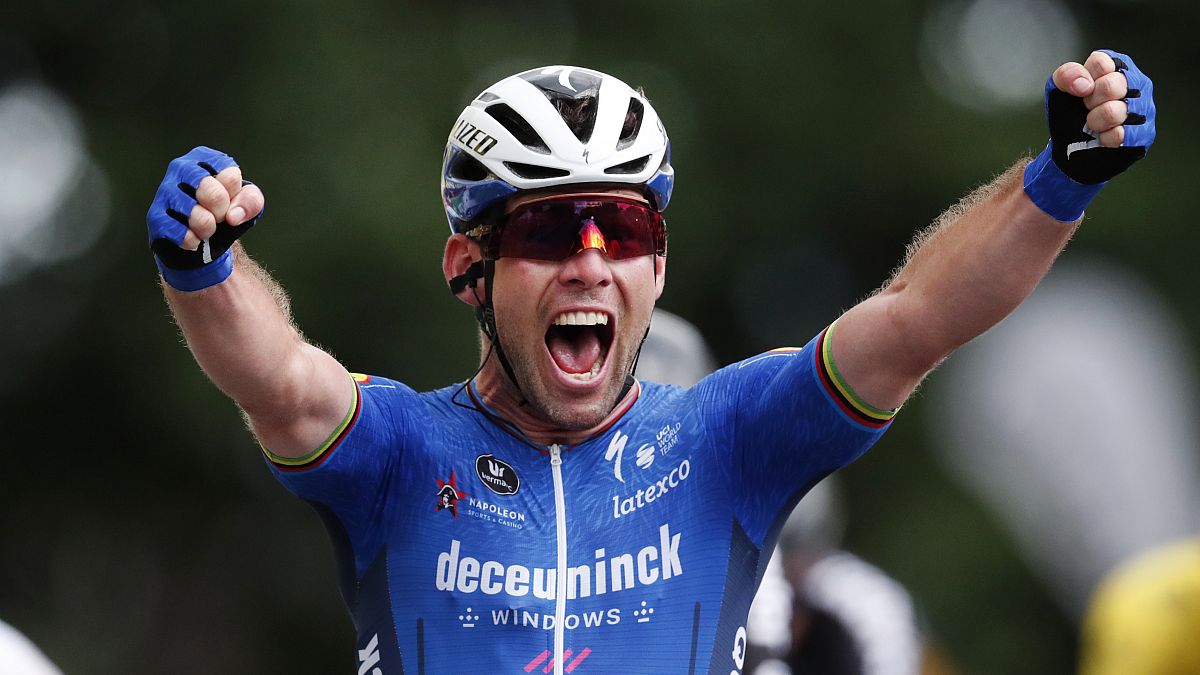 Britain's Mark Cavendish celebrates as he crosses the finish line to win the fourth stage of the Tour de France on June 29, 2021.