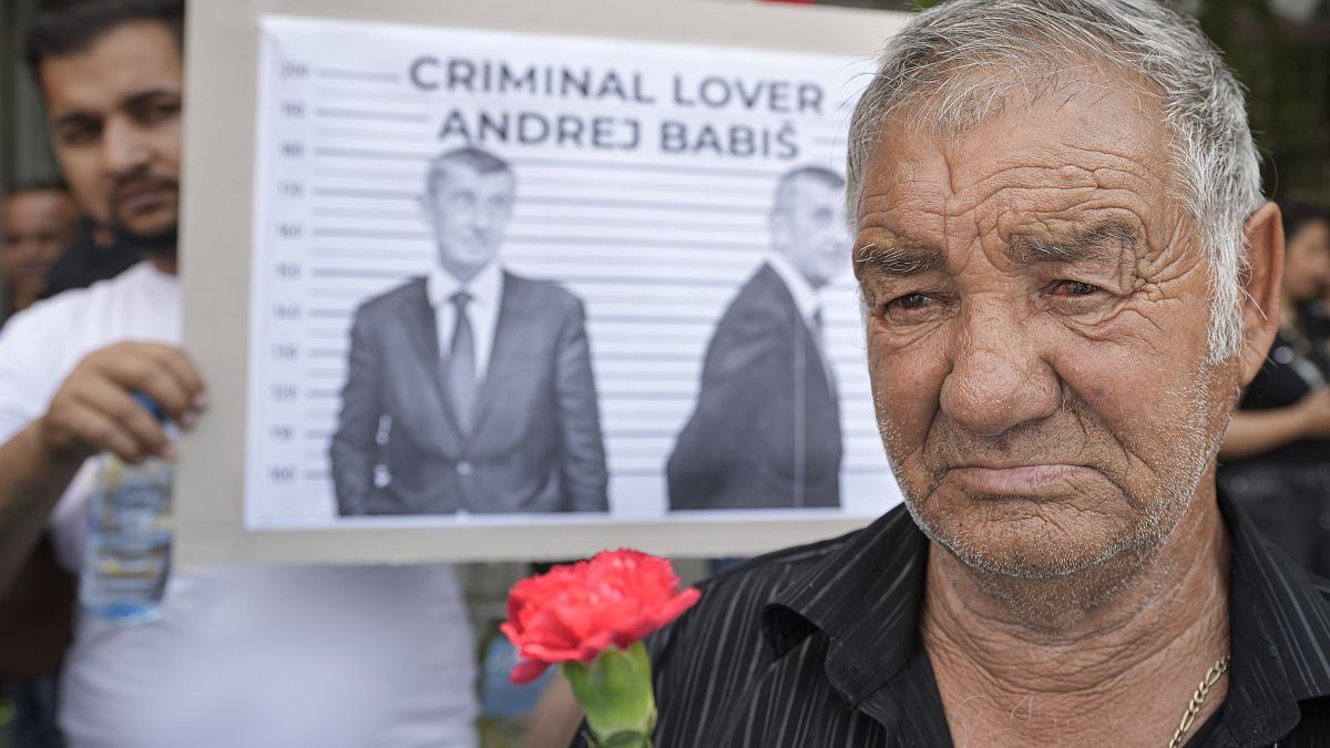 A man holds a carnation during a rally called by Roma organizations to honor a Roma man Stanislav Tomas who died after police officers held him in the Czech Republic.