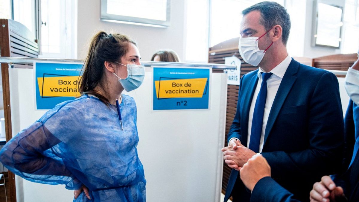 Krankenschwester und Gesundheitsminister Olivier Véran in einem Impfzentrum
