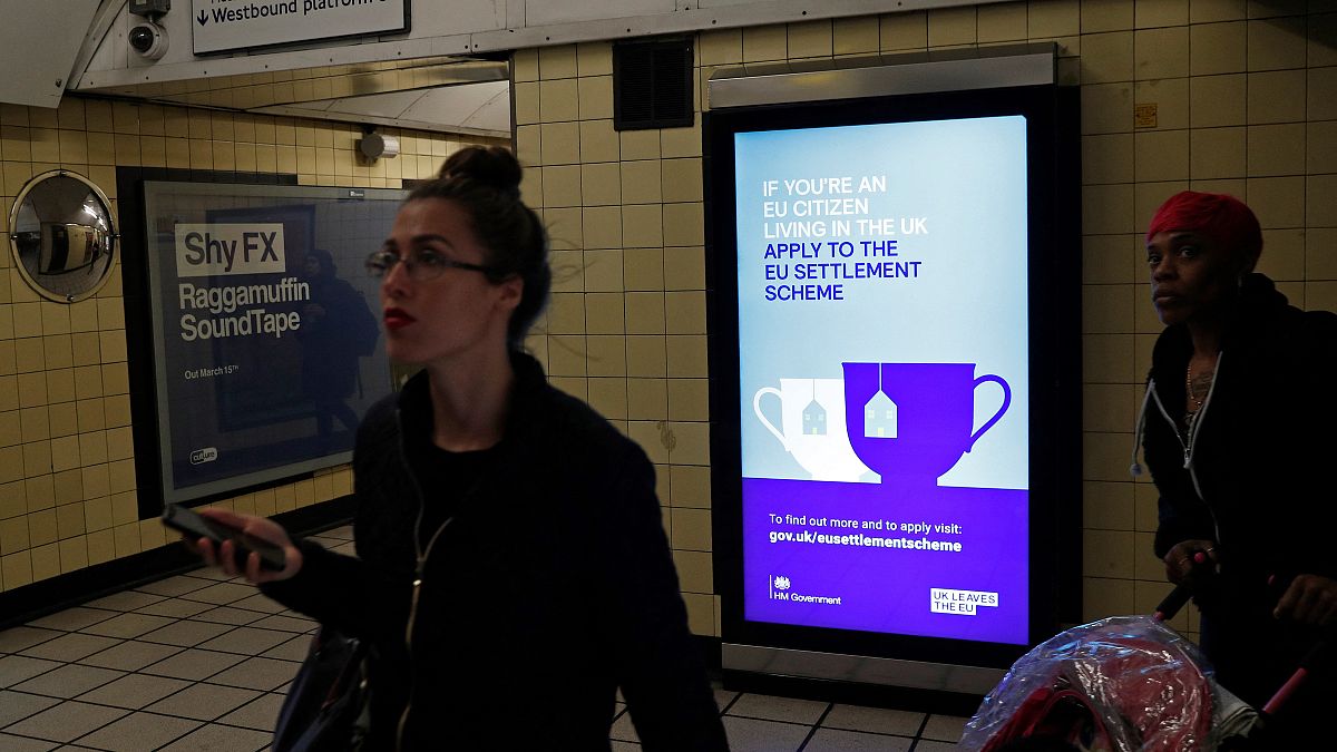 A poster encourages EU nationals to apply to the Government's post-Brexit EU settlement scheme  at South Kensington underground station in London on March 25, 2019.