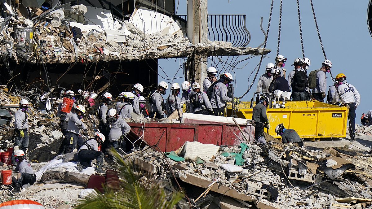 workers search the rubble at the Champlain Towers South Condo in Surfside, Fla. on June 28, 2021.