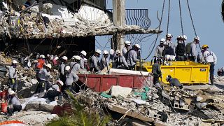 workers search the rubble at the Champlain Towers South Condo in Surfside, Fla. on June 28, 2021.