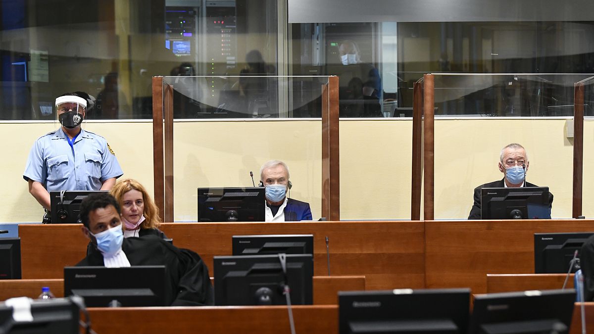 Jovica Stanisic, centre, and his subordinate Franko "Frenki" Simatovic, right, appear in court at the UN International Residual Mechanism for Criminal Tribunals.