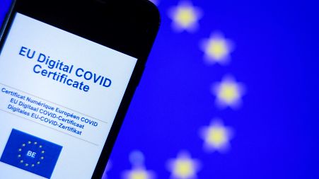 A picture taken on June 16, 2021 in Brussels shows the screen of a mobile phone bearing a EU Digital Covid certificate.