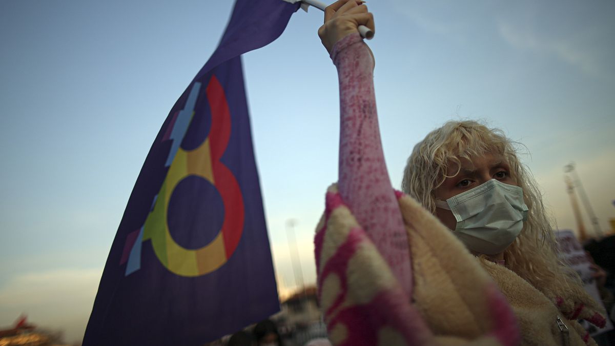 A protester holds a flag during an April demonstration against Turkey's withdrawal in Istanbul.