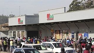 People queue to buy food after deadly protests in eSwatini capital