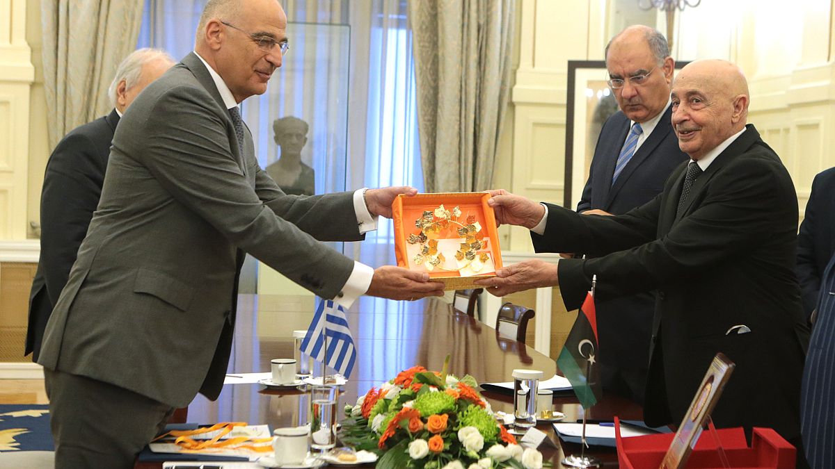 Ο υπουργός Εξωτερικών Νίκος Δένδιας (Α) ανταλλάζει δώρο με τον Πρόεδρο της Βουλής των Αντιπροσώπων της Λιβύης Αγκίλα Σάλεχ (Aguila Saleh Eissa) (Δ)