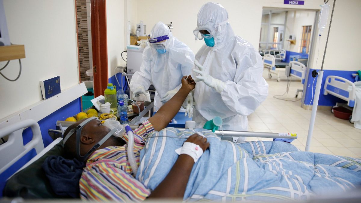 In this Thursday June 17, 2021 file photo medical staff wearing protective equipment attend to patients affected by COVID-19 in Kenya.