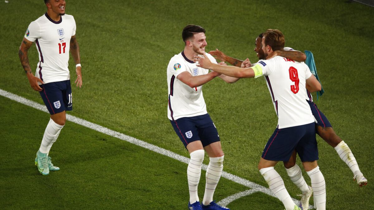 England's Harry Kane, right, celebrates after scoring his side's third goal during the Euro 2020 soccer championship quarterfinal match between Ukraine and England.