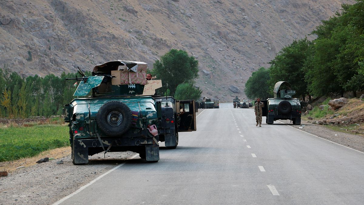 Afghan soldiers pause on a road at the front line of fighting between Taliban and Security forces, near the city of Badakhshan, northern Afghanistan, Sunday, July. 4, 2021