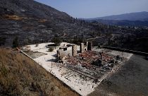 A burnt house is seen on outskirts of Ora village, in the background is the Larnaca mountain region, Cyprus, Sunday, July 4, 2021.