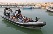 Migrants rescued by Tunisia's national guard from the Mediterranean arrive at the port of el-Ketef near the Libyan border, June 27, 2021.