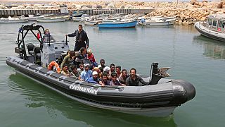 Migrants rescued by Tunisia's national guard from the Mediterranean arrive at the port of el-Ketef near the Libyan border, June 27, 2021. 