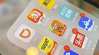 The ride-hailing app Didi is seen near other Chinese apps on a phone in Beijing